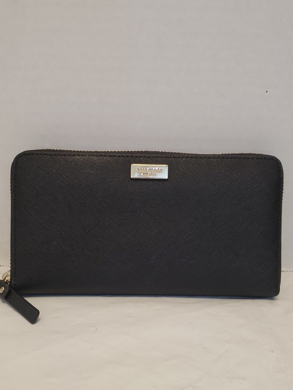 kate spade black zip-around Saffiano leather wallet with gold plaque